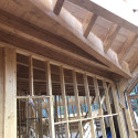 Hybrid timber frame construction with glulam beams and stick frame walls