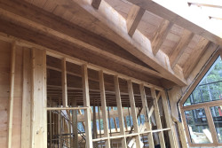 Photo: Hybrid timber frame construction with glulam beams and stick frame walls in European Glulam Home